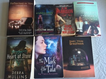 Pictures of books in giveaway: Reflected in You, Nightwalker, Dead Witch Walking, The Mark of the Tala, Angry Young Spaceman, Heart of Stone, The Time Traveler's Wife