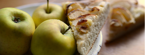 photo of green apples and a slice of apple cake